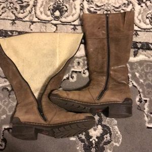 Brown boots hit under the knee. Well worn.